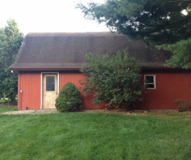 The Outside View of a barn in a Lawn